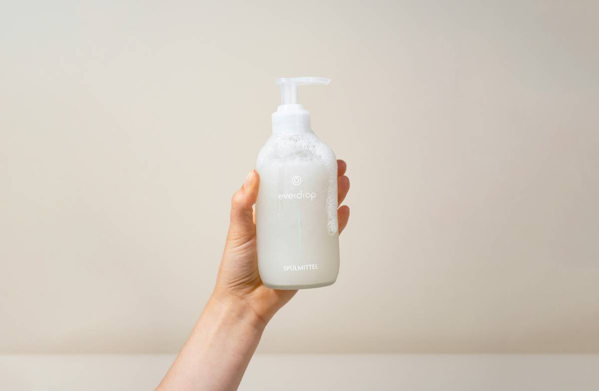 Woman applying cleansing product shower gel wash simple to shoulder in shower