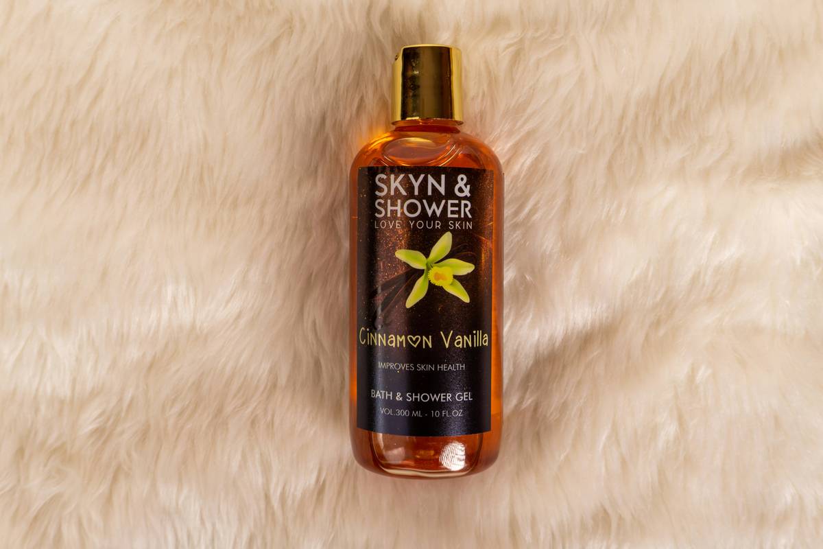woman using cleansing product shower gel wash bath with healthy glowing skin